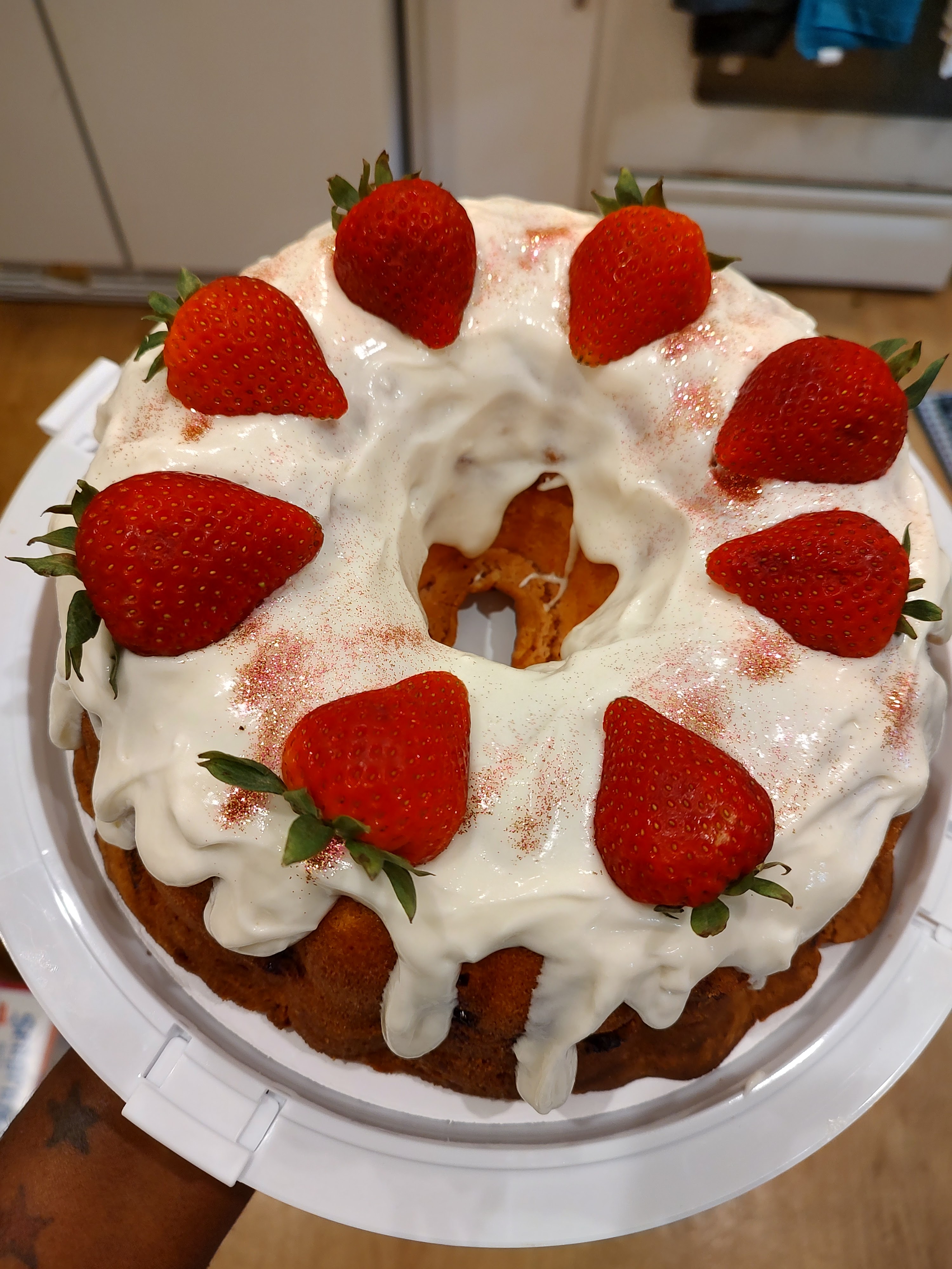 Strawberry bundt cake with white glaze and fresh strawberries