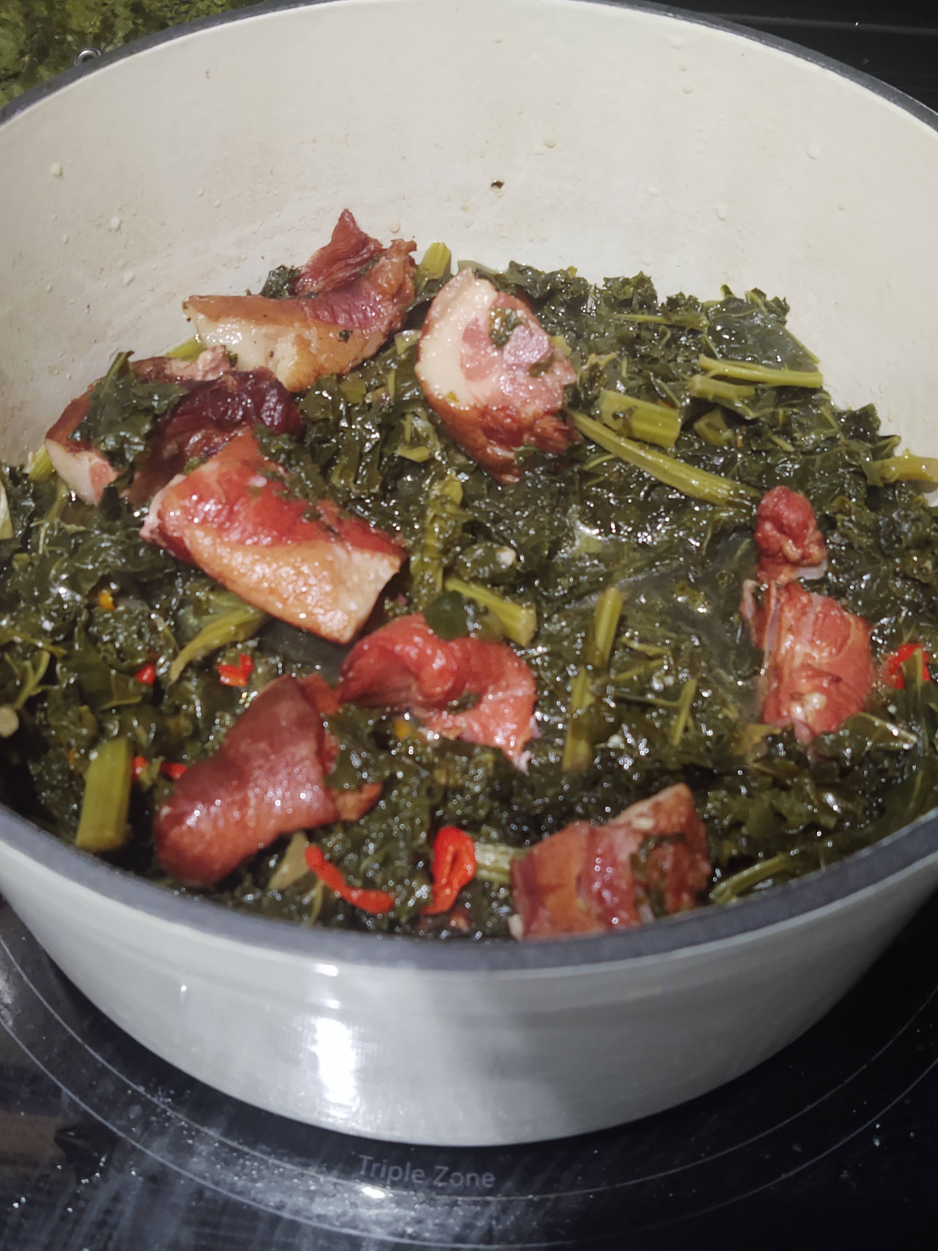 Slow-cooked collard greens with smoked meat